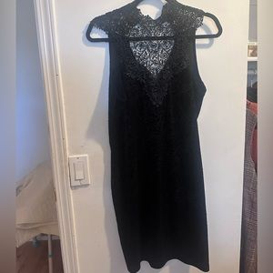 This is a lace high neck, velvet textured black dress in size XL. Never worn.